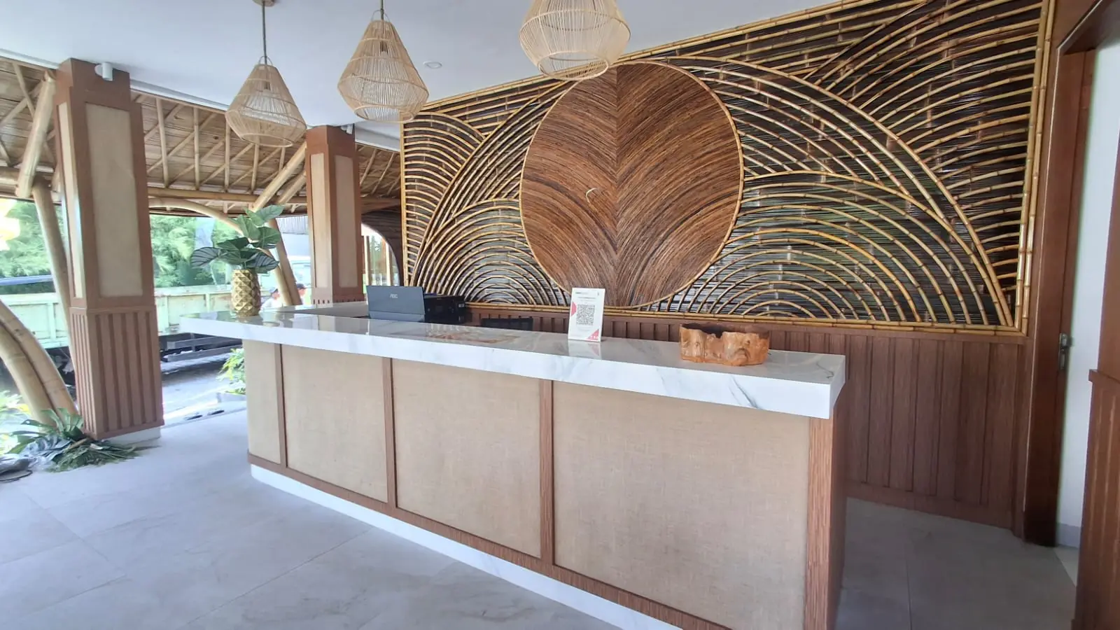Lokalé reception desk and rattan sunburst wall