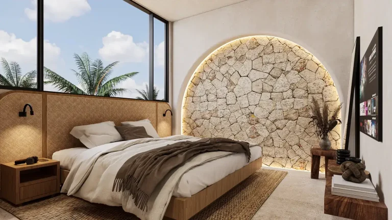 Guesthouse studio bedroom in Mauritius designed remotely by Bali Best Design, with a backlit arched natural-stone headboard, rattan bed wall and palm view