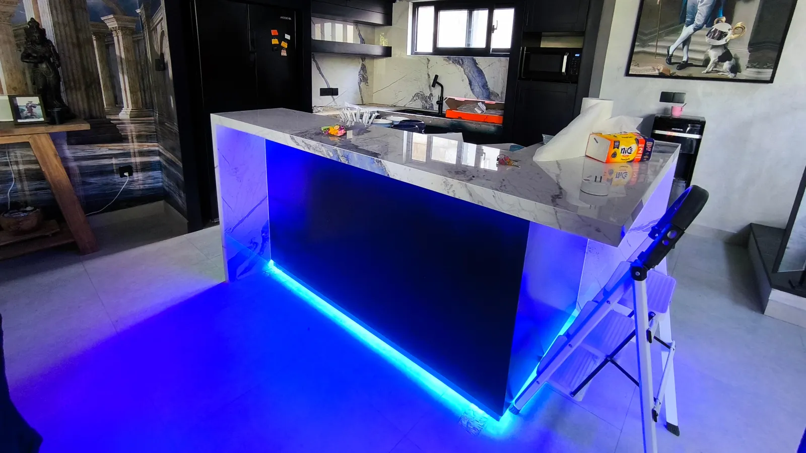 Navy blue villa kitchen in Kayu Tulang, Canggu, with a Quadra Glacier Blue marble waterfall island and blue LED lighting, designed by Bali Best Design