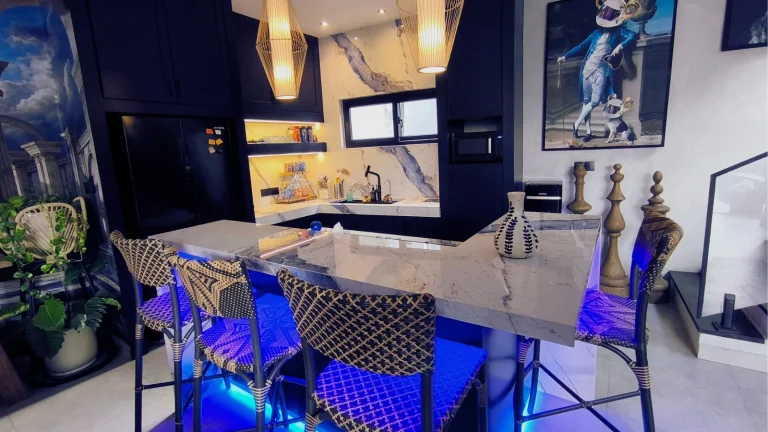 The finished blue-veined marble backsplash and dark navy cabinetry in the completed Soho Blue villa kitchen, Kayu Tulang, Canggu